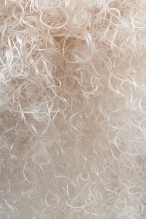 Vertical closeup of a curly blonde wig with selective focusの写真素材