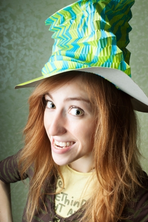 Funny clown girl with big hat smilingの写真素材