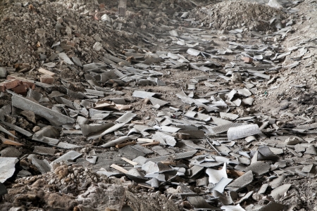 Construction site debris with pieces of asbestos slates and selective focusの写真素材