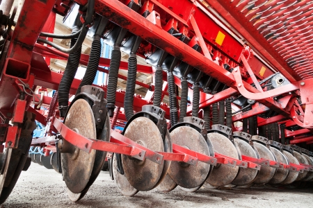 Closeup of cultivator knives of plowing tractorの写真素材