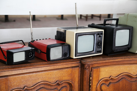 Row of portable vintage TV sets with selective focusの写真素材