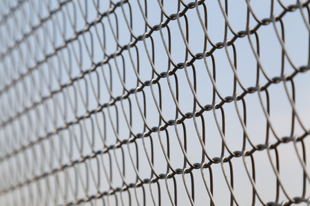 Closeup of wire mesh fence with selective focusの写真素材
