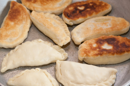 preparing patty on frying pan with selective focusの写真素材