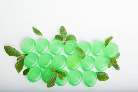 Bunch of cough lozenges with mint green leaves