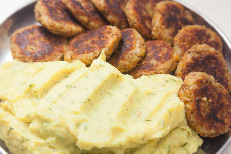 Closeup of plate with mashed potatoes and cutlets
