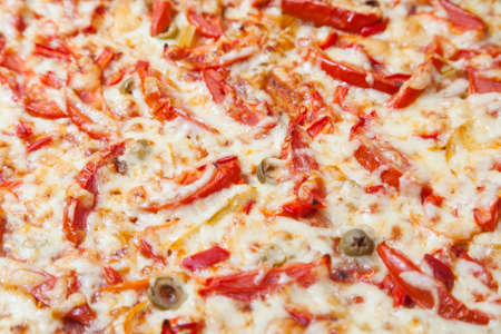 Closeup of pizza with lots of cheese and tomatoesの写真素材
