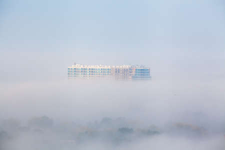 Highrise building under construction in the fogの写真素材
