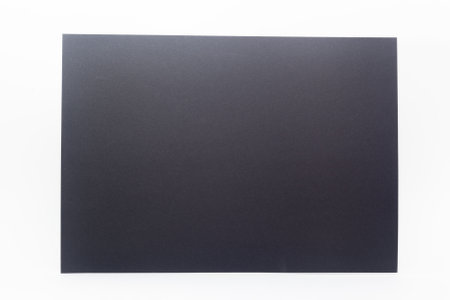 Closeup of black paper sheet against white backgroundの写真素材