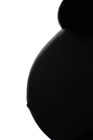 Belly pregnant woman silhouette on a white backgroundの写真素材