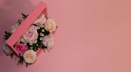 postcard template, copy space- pink roses in a basket on a pink background