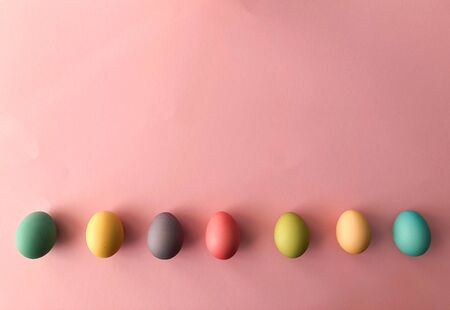 Template greeting card, copy Space for the holiday Easter eggs colorful on a pink background.の写真素材
