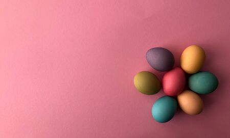 Template greeting card, copy Space for the holiday Easter eggs colorful on a pink background.の写真素材
