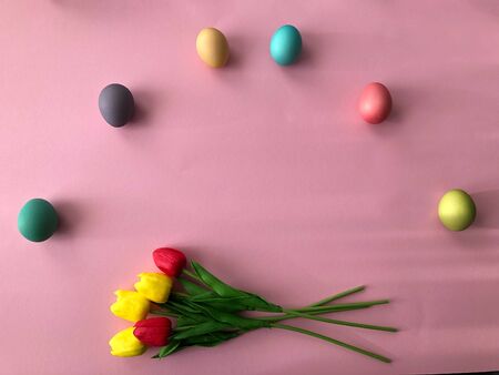 Template greeting card, copy Space for the holiday Easter eggs colorful on a pink background.の写真素材