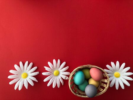 Template greeting card, copy Space for the feast of Easter, eggs colored with a red background.の写真素材