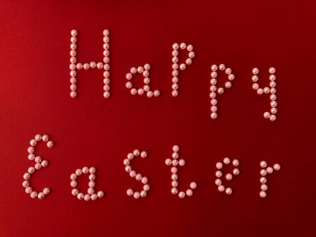 Postal card with the inscription - Happy Easter on a red backgroundの写真素材