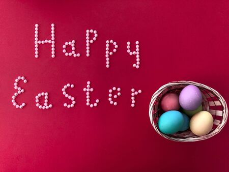Postal card with the inscription - Happy Easter on a red backgroundの写真素材