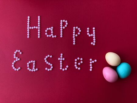 Postal card with the inscription - Happy Easter on a red backgroundの写真素材