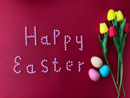 Postal card with the inscription - Happy Easter on a red backgroundの写真素材