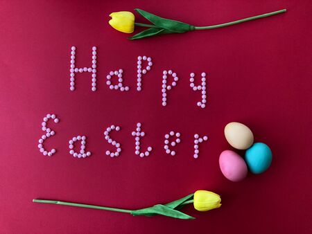 Postal card with the inscription - Happy Easter on a red backgroundの写真素材