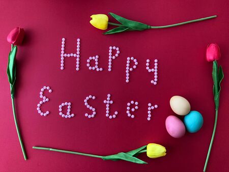 Postal card with the inscription - Happy Easter on a red backgroundの写真素材