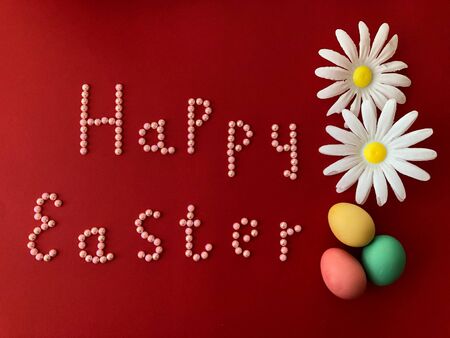 Postal card with the inscription - Happy Easter on a red backgroundの写真素材