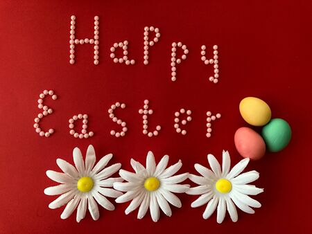 Postal card with the inscription - Happy Easter on a red backgroundの写真素材