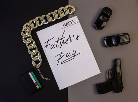 Holiday greeting card for Father's Day on a black background - the machine, gun, with the text - Happy Father's Dayの写真素材