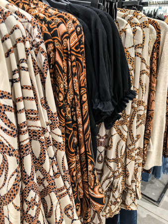 Women's clothing on a hanger in the store - coats, jackets, blouses