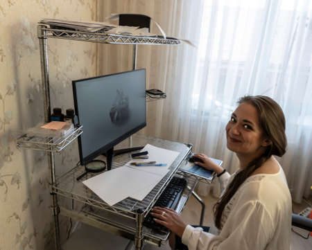 photo of a beautiful young girl who works at home, distant work