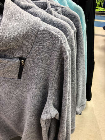 Women's clothing on a hanger in the store - coats, jackets, blouses