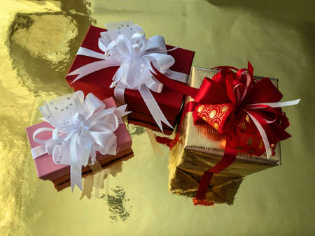 photo close-up Christmas boxes with presents on a gold background