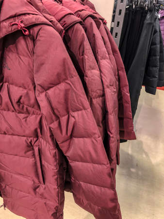 Women's clothing on a hanger in the store - coats, jackets, blouses