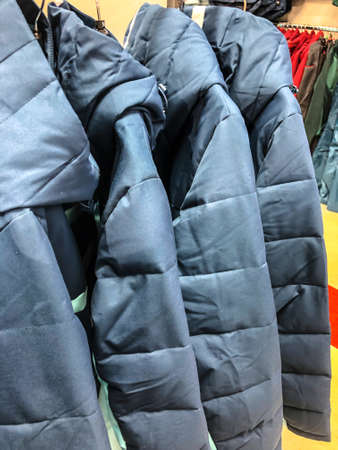 Women's clothing on a hanger in the store - coats, jackets, blousesの写真素材