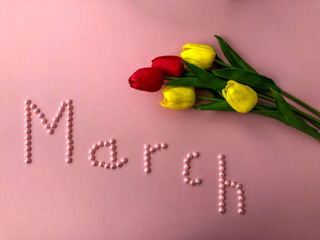 written the name of the month of March beads