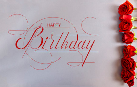postcard, Internet banner, flat lay with a birthday greeting, with the inscription - happy birthday With red rosesの写真素材
