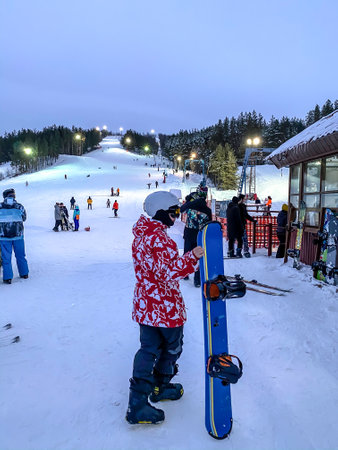 Fedotovo, Russia - January 7, 2021: Ski base, resort. Young woman with snowboard in helmetのeditorial素材