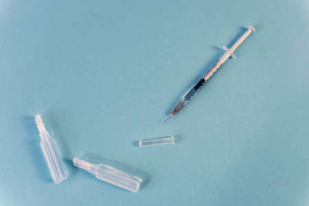 Flat Lay for medical theme and vaccinations from COVID-19. Medicine, vaccine, syringe, mask.