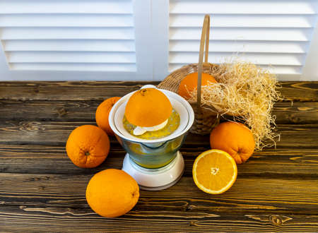 Photo, Flat Lay Oranges and Juicers on a wooden brown background