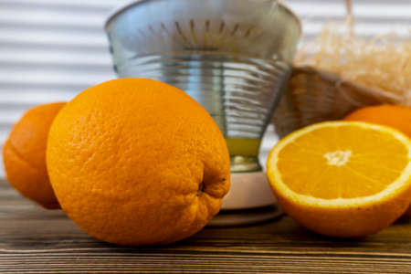 Photo, Flat Lay Oranges and Juicers on a wooden brown backgroundの写真素材