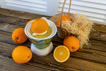 Photo, Flat Lay Oranges and Juicers on a wooden brown background