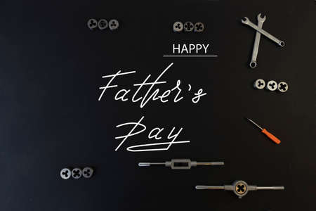 Happy Father's Day. Flat lay on father's day theme. Black background. On the topic of car mechanic and motorcyclist, bikerの写真素材