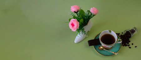 coffee, flowers, candles on a pistachio background as a symbol of home warmth and coziness, beauty and a wonderful morningの写真素材