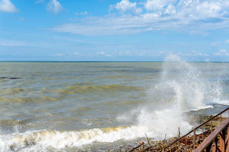 the black sea after the storm, brown water and debris on the shore
