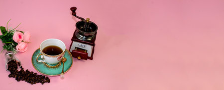 coffee, flowers, candles on a pink background as a symbol of home warmth and coziness, beauty and a wonderful morning breakfastの写真素材