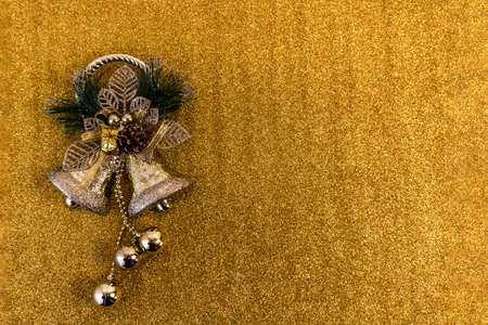 christmas and new year flat lay with copy space and with a new year toy on a gold backgroundの写真素材