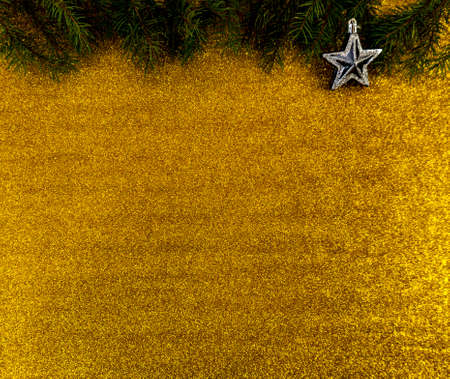 christmas and new year flat lay with copy space and with a new year toy on a gold backgroundの写真素材