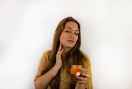 young beautiful woman uses face creamの写真素材