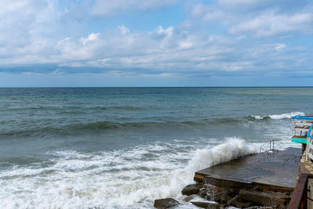 small storm on the sea, waves hitting the shore