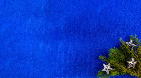 christmas and new year flat lay with copy space and with a new year toy on a blue backgroundの写真素材