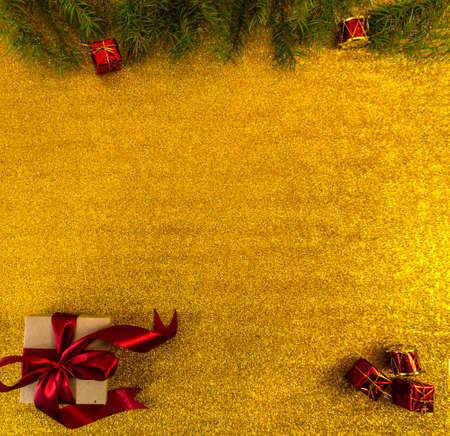 christmas and new year flat lay with copy space and with a new year toy on a gold backgroundの写真素材